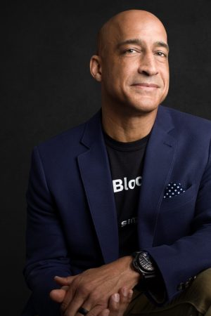 Jason Kelley, Chairman of the Board, sitting on a black background.
